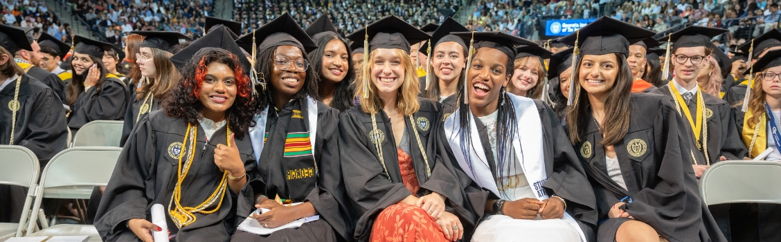 B.S. Computational Media students smiling in group at the Georgia Tech Commencement ceremony.