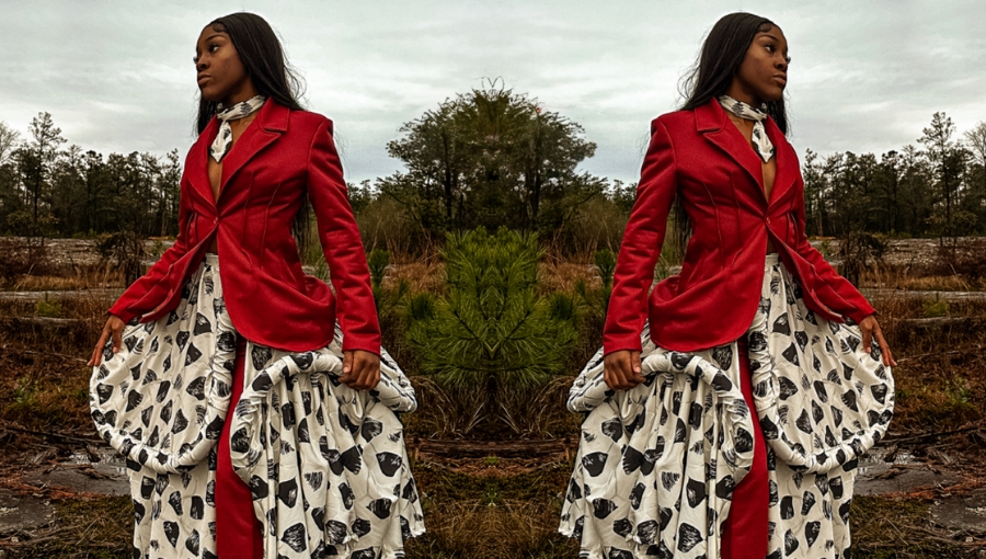 Portrait of a woman in red jacket and white dress designed by LMC student Elijiah